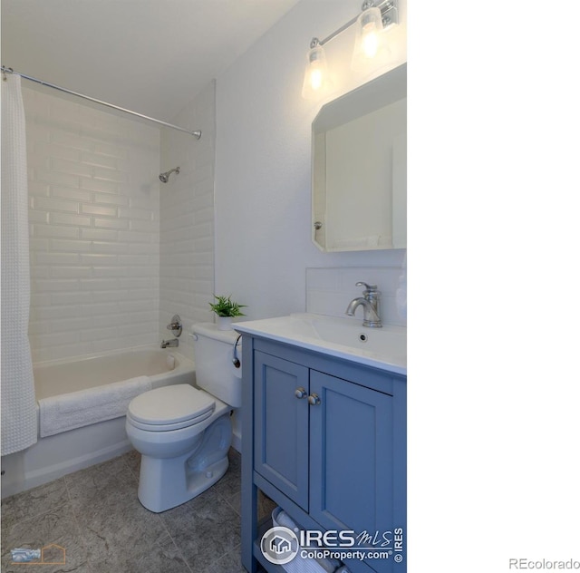bathroom featuring vanity, tile patterned flooring, shower / bath combination with curtain, and toilet