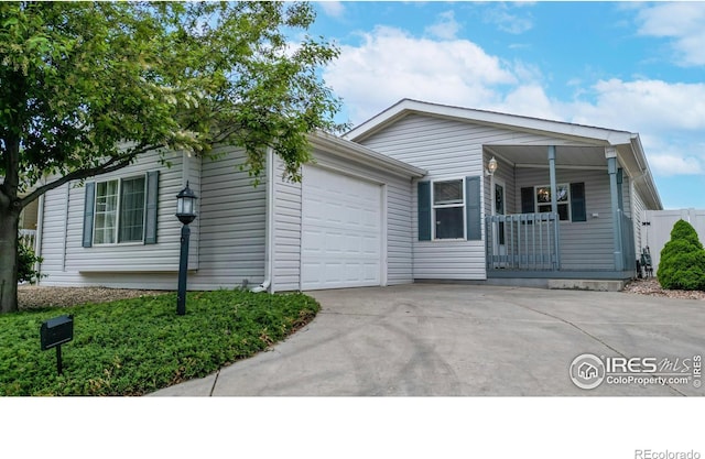 view of front of house with driveway, covered porch, and an attached garage