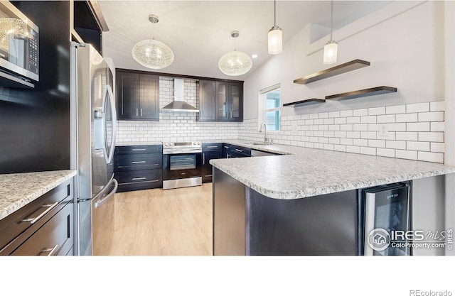 kitchen featuring a sink, open shelves, wine cooler, appliances with stainless steel finishes, and wall chimney exhaust hood