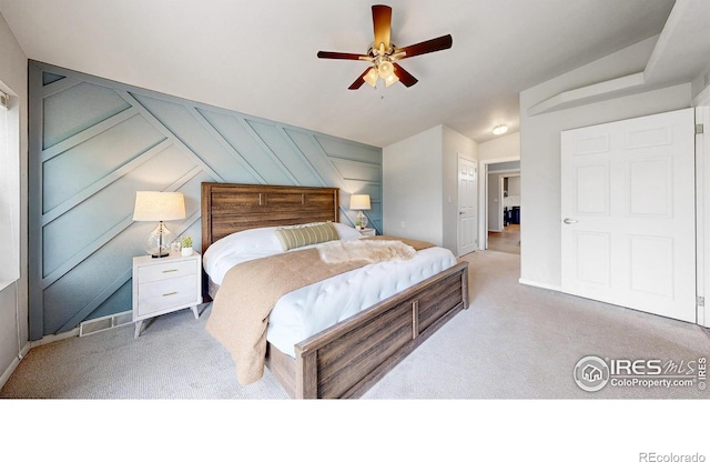 bedroom with a ceiling fan, visible vents, and carpet floors