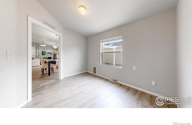 empty room with visible vents and wood finished floors