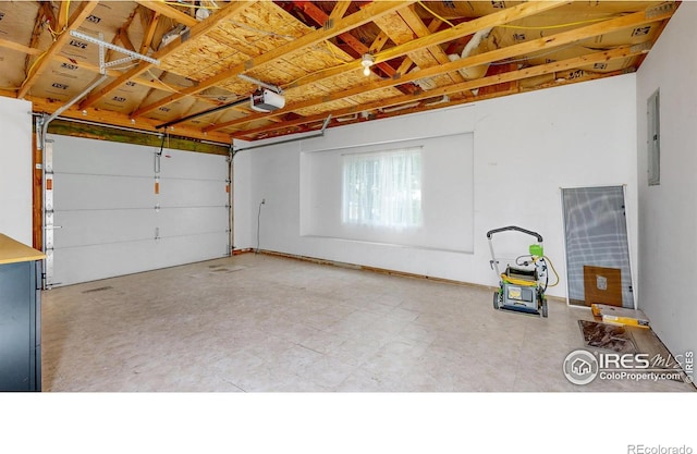 garage featuring electric panel and a garage door opener