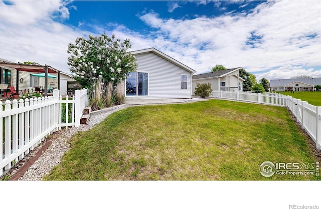 back of house featuring a patio, a lawn, and a fenced backyard