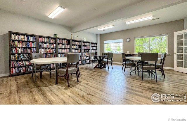 dining area with baseboards and wood finished floors