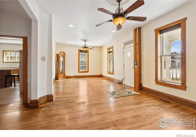 interior space featuring recessed lighting, baseboards, a ceiling fan, and wood finished floors