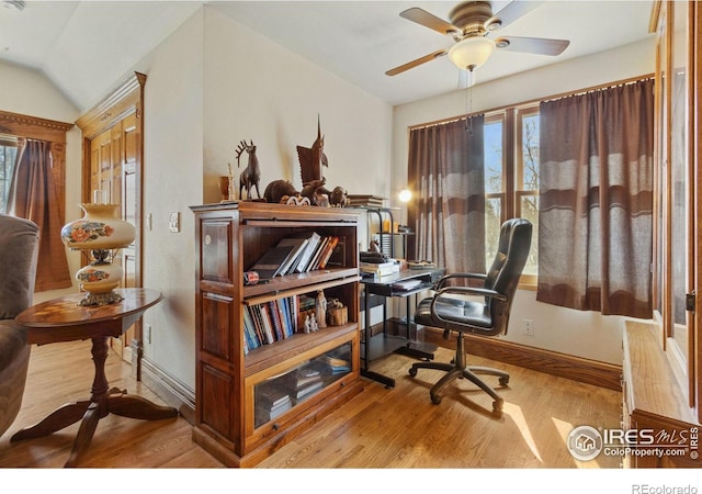 office featuring a healthy amount of sunlight, wood finished floors, and a ceiling fan