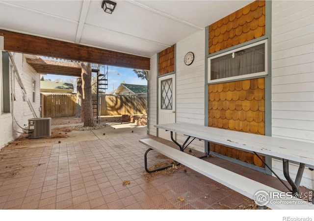 view of patio / terrace with central AC and fence