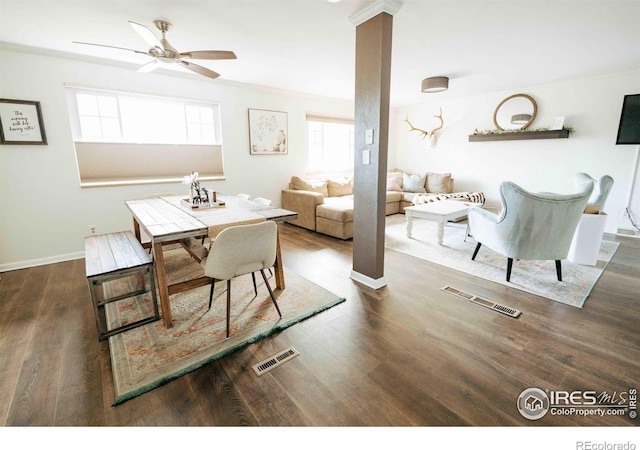 dining room with visible vents, ornamental molding, a ceiling fan, wood finished floors, and baseboards