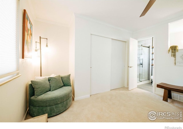 sitting room with crown molding, ceiling fan, and carpet floors