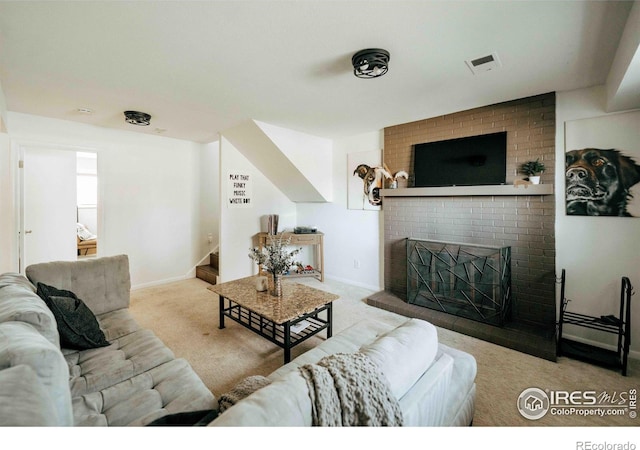 carpeted living room featuring visible vents, baseboards, a fireplace, and stairway