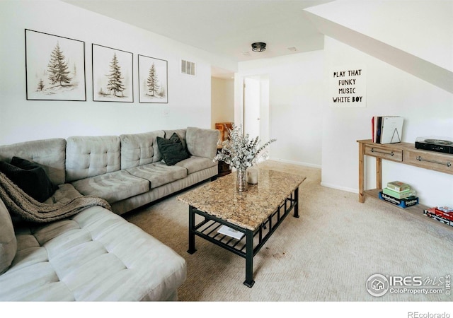 carpeted living room with baseboards and visible vents