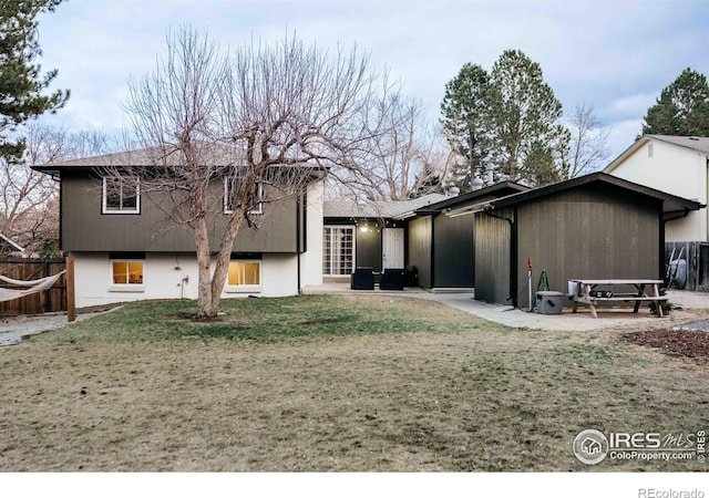 rear view of property with a patio area, fence, and a lawn