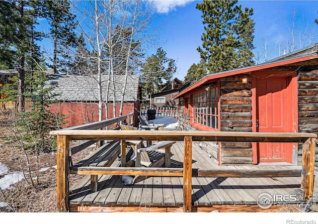 wooden terrace featuring fence