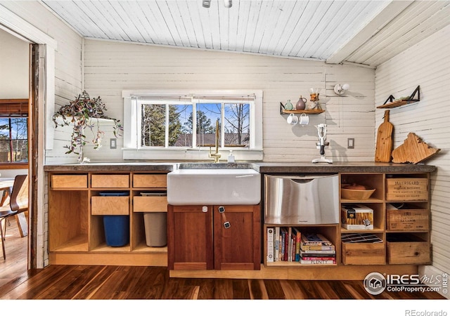 kitchen with a sink, open shelves, dark countertops, and dark wood-style flooring