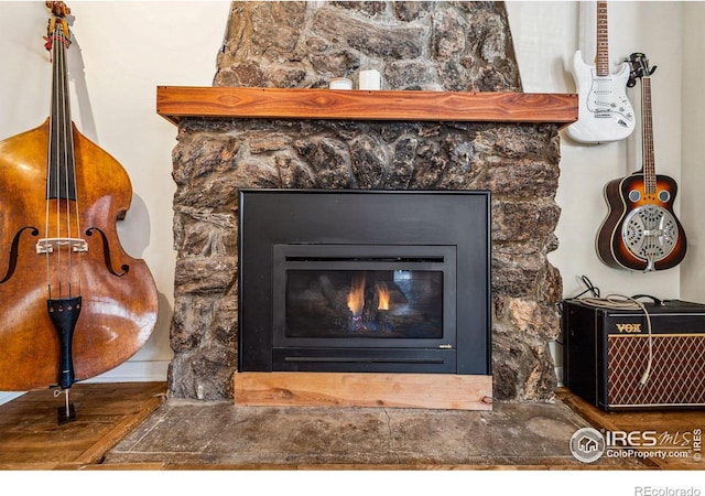 interior details featuring a stone fireplace