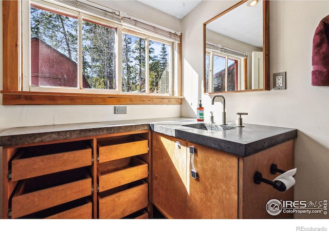 kitchen featuring dark countertops and a sink