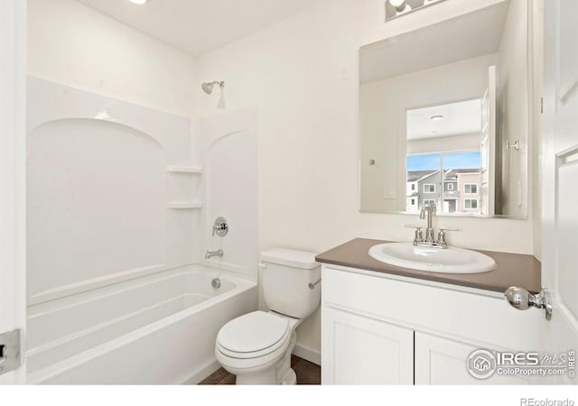 bathroom featuring bathing tub / shower combination, toilet, and vanity