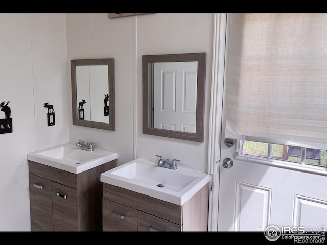 bathroom with a sink and two vanities