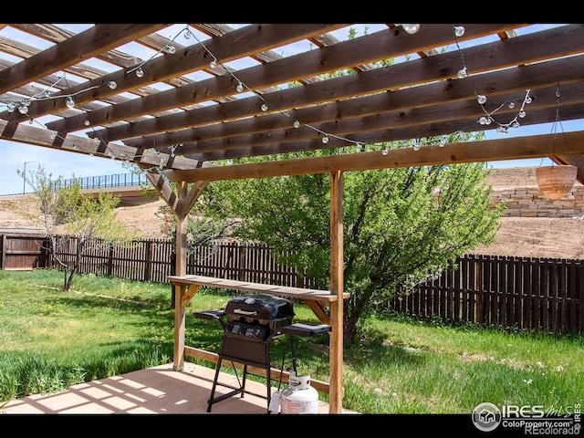 exterior space with a fenced backyard, a pergola, and grilling area