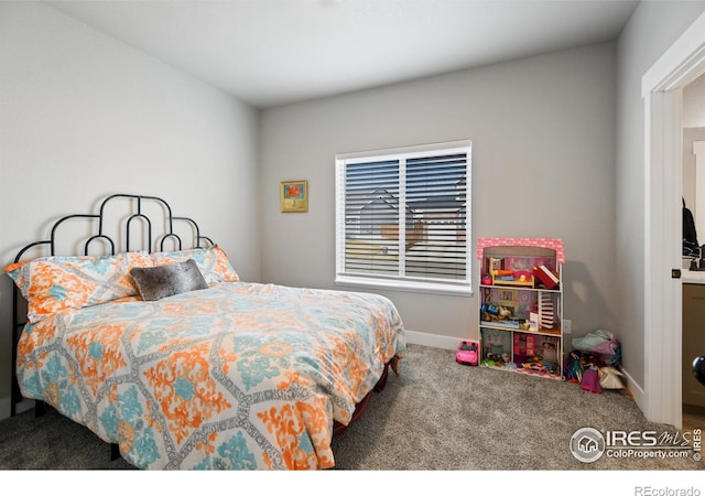 bedroom featuring carpet flooring and baseboards