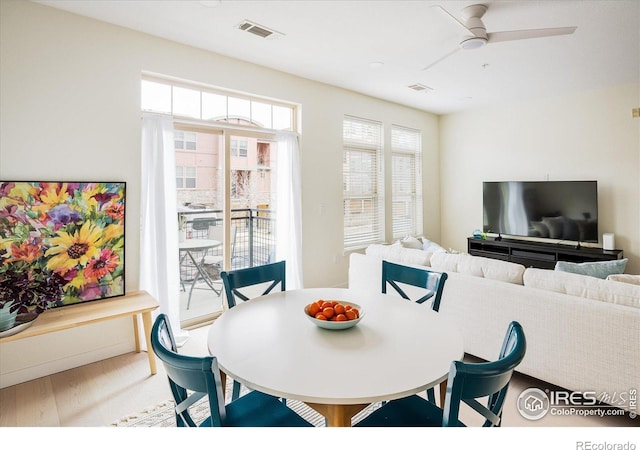 dining area featuring visible vents, ceiling fan, and wood finished floors