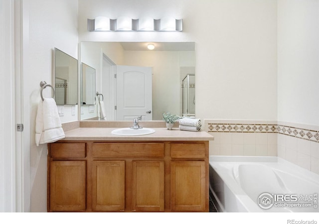 full bathroom featuring a bath and vanity