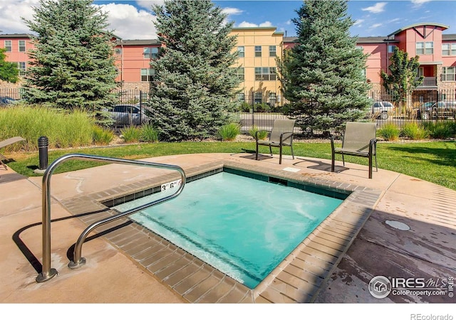 view of swimming pool with a patio and fence