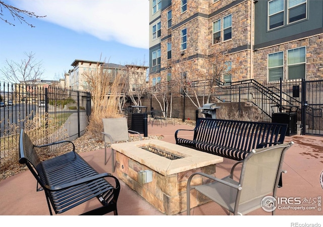 view of patio with fence, area for grilling, and an outdoor fire pit