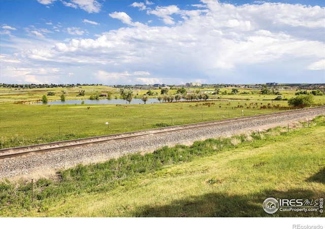 view of road featuring a water view and a rural view