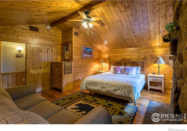 bedroom featuring vaulted ceiling with beams, visible vents, and wood-type flooring