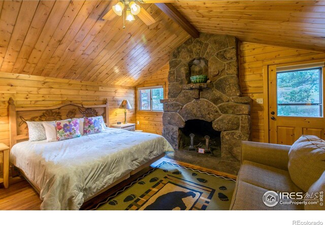 bedroom with wood ceiling, wood walls, vaulted ceiling with beams, and wood finished floors