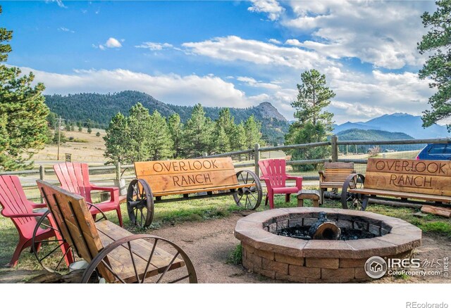 3501 Devils Gulch Rd, Estes Park, CO 80517 - view of patio / terrace featuring a fire pit and a mountain view