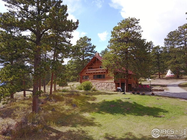 3501 Devils Gulch Rd, Estes Park, CO 80517 - view of front of home with a front lawn, a chimney, and stone siding