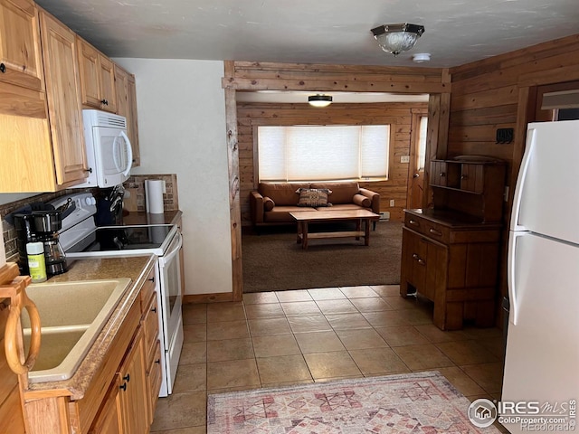 3501 Devils Gulch Rd, Estes Park, CO 80517 - kitchen featuring white appliances, light colored carpet, light tile patterned floors, wood walls, and open floor plan