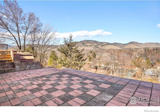 view of patio / terrace with a mountain view and stairs