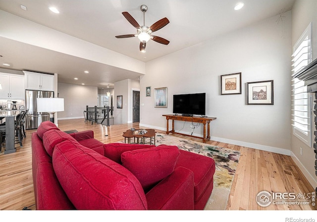 living area featuring recessed lighting, baseboards, light wood finished floors, and ceiling fan