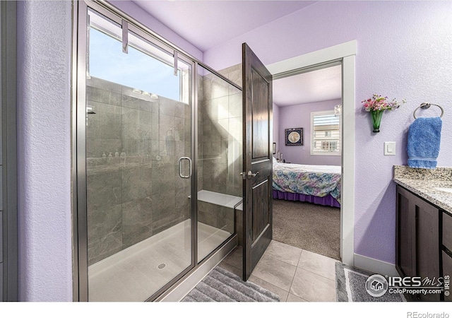 ensuite bathroom featuring ensuite bath, a shower stall, vanity, and tile patterned flooring