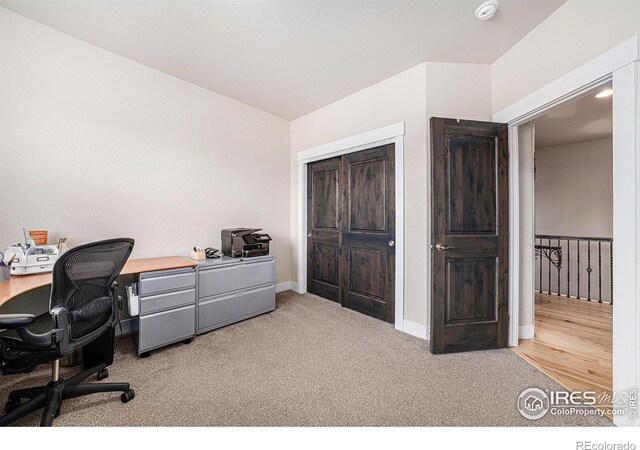 carpeted office space with baseboards