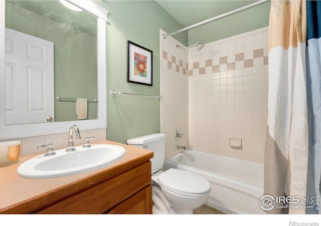 full bathroom with vanity, toilet, a textured wall, and shower / bath combo