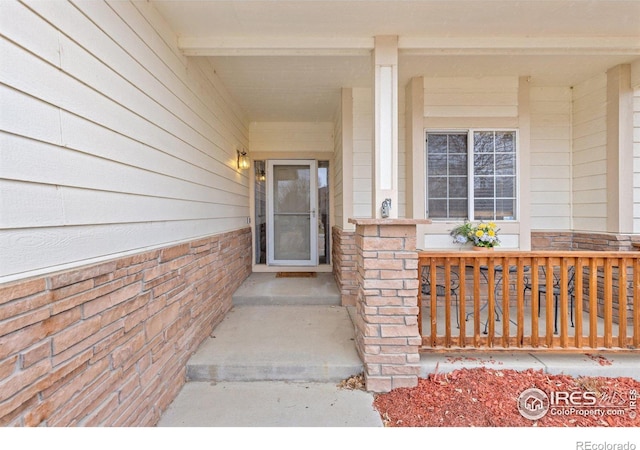 view of exterior entry with a porch