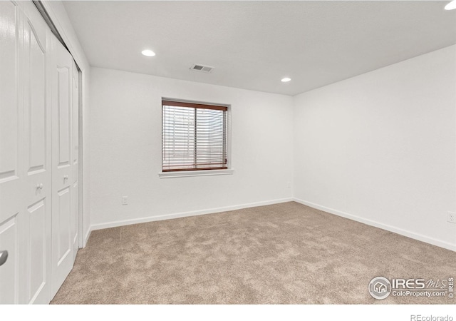 unfurnished bedroom with visible vents, baseboards, carpet floors, recessed lighting, and a closet