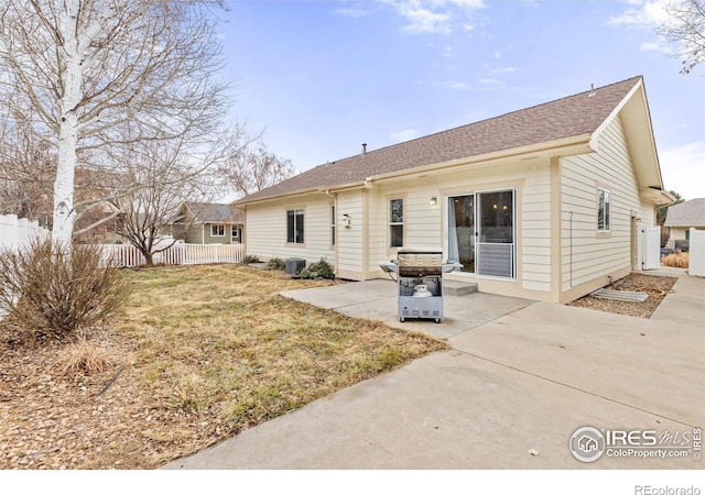 rear view of house featuring central AC unit, a lawn, a patio, and fence