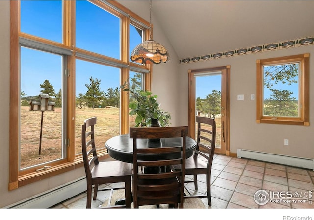 dining room with a baseboard heating unit, baseboards, and high vaulted ceiling