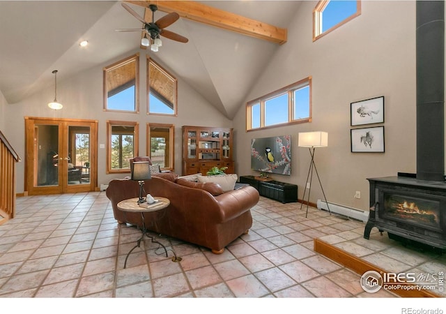 living room with baseboard heating, high vaulted ceiling, a wood stove, and ceiling fan