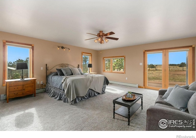 bedroom featuring a baseboard heating unit, baseboards, carpet, and access to exterior