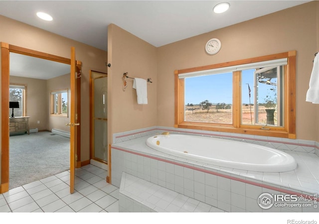 bathroom featuring tile patterned flooring, a shower stall, baseboards, baseboard heating, and a bath