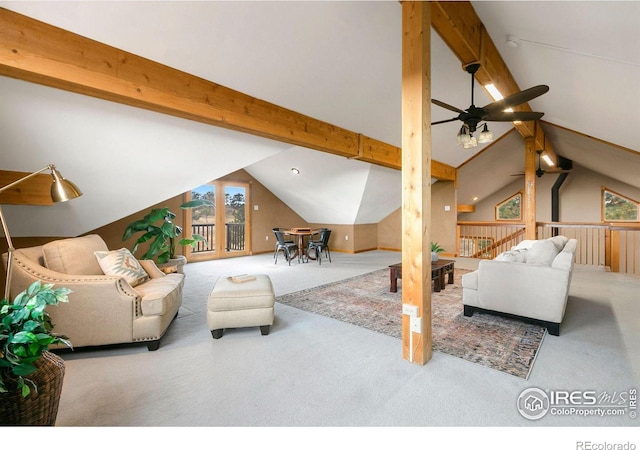 carpeted living area with ceiling fan and vaulted ceiling with beams