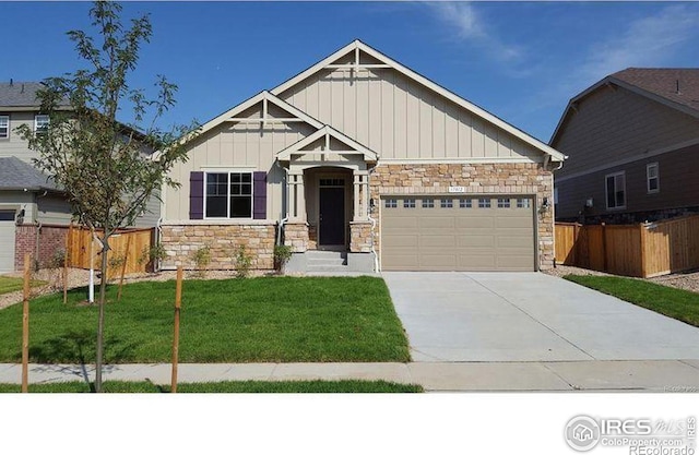 17012 Lipan St, Broomfield, CO 80023 - craftsman house featuring stone siding, board and batten siding, a garage, and concrete driveway