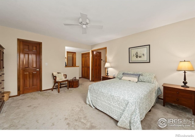 carpeted bedroom with baseboards and a ceiling fan