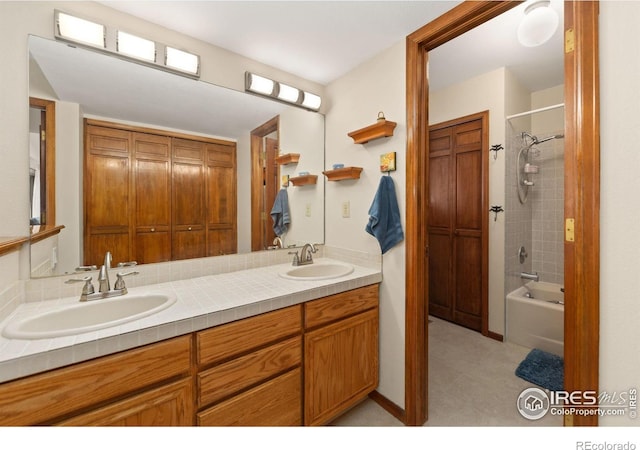 full bathroom featuring bathtub / shower combination, double vanity, and a sink